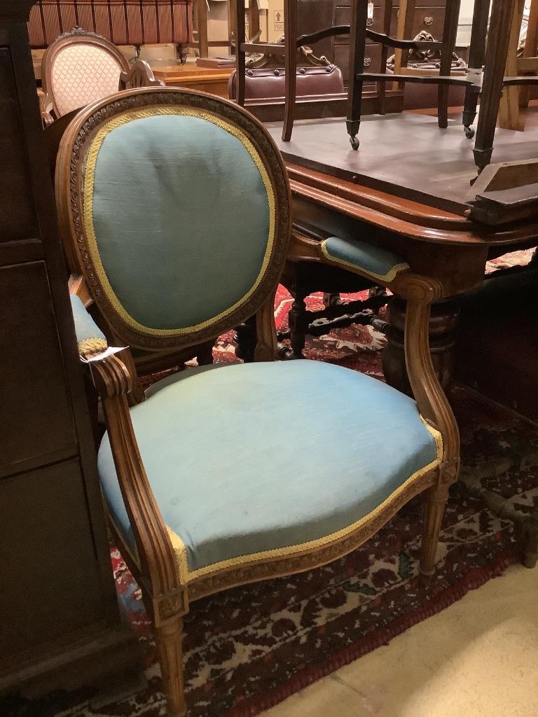 A pair of Louis XVI style carved and stained and beech fauteuils, width 60cm, depth 55cm, height 92cm